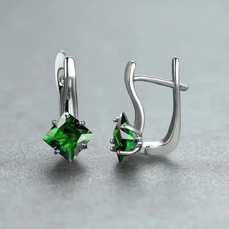 A pair of women's copper earrings with a simple diamond design and an inlaid zircon stone.