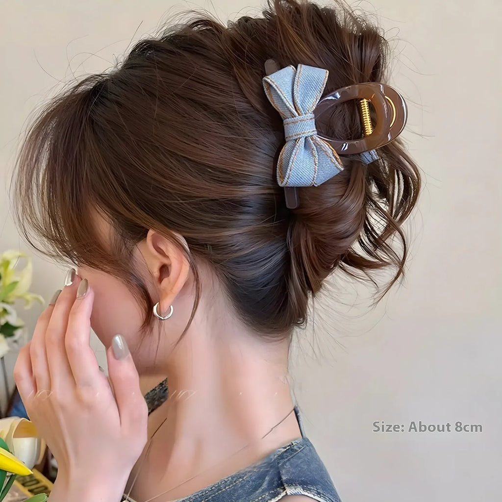 Denim blue bow hair barrette for women with metal clip, shown as a cloth bow hair accessory