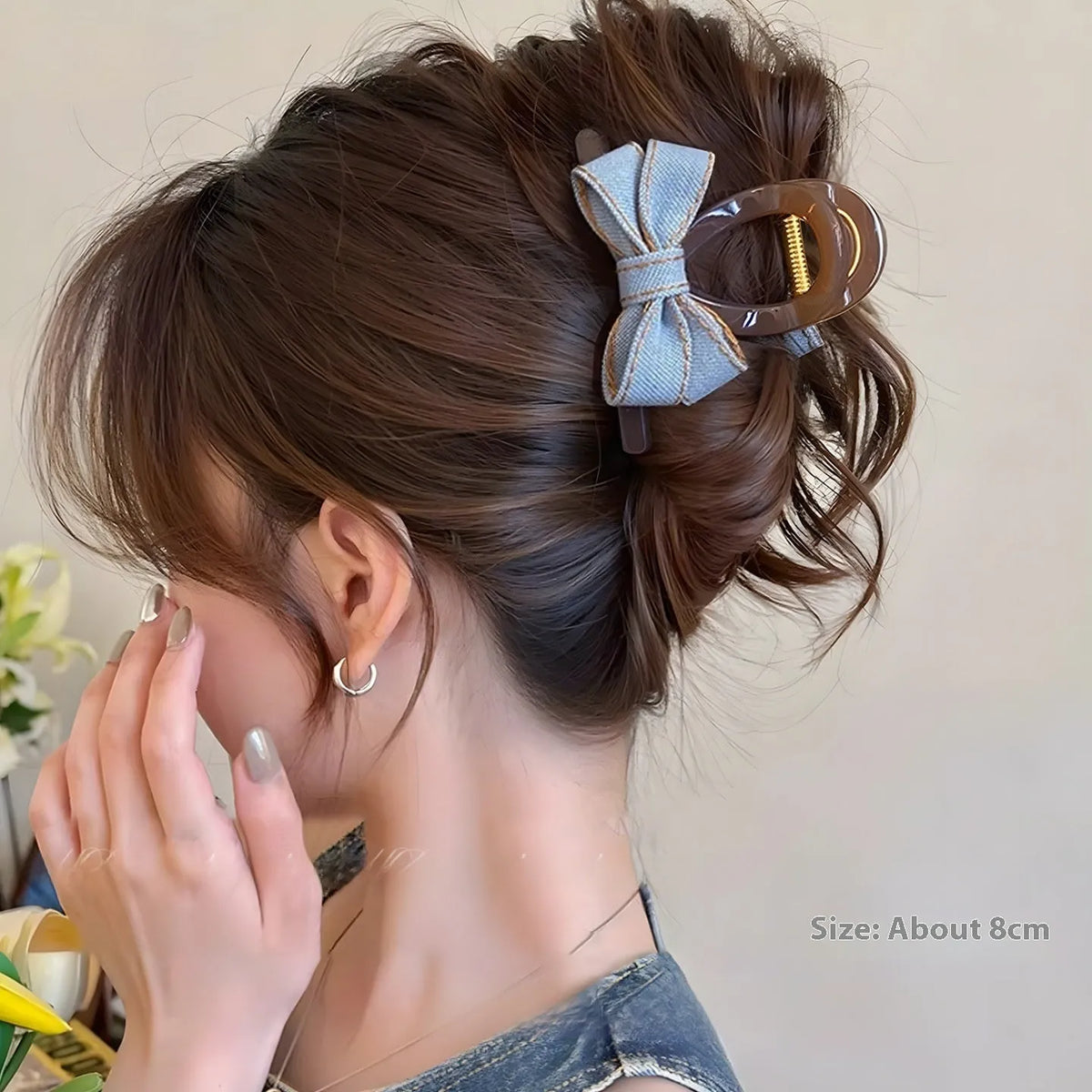Denim blue bow hair barrette for women with metal clip, shown as a cloth bow hair accessory