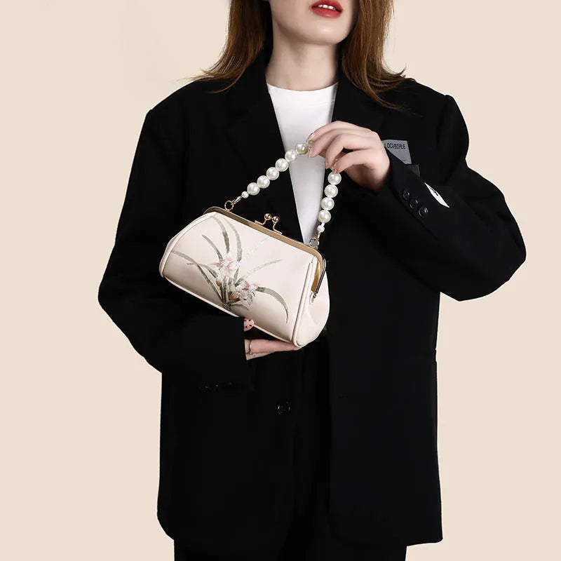 Beige women's shoulder bag with embroidery on soft PU leather in shell shape