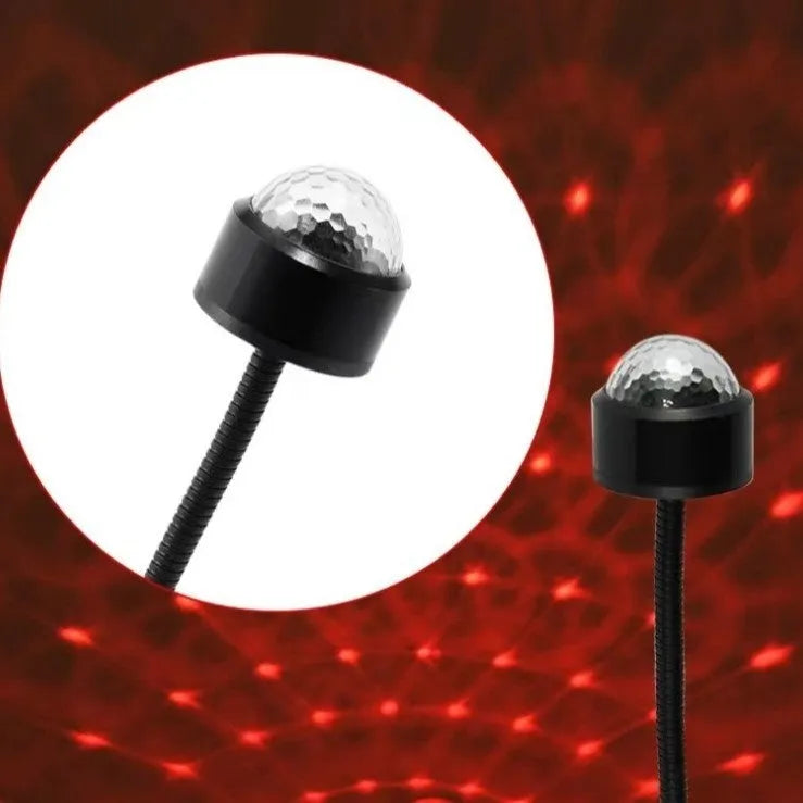 USB car atmosphere projection star light in black ABS plastic plugged into a vehicle interior