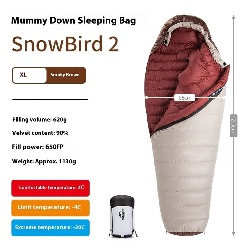 Goose down mummy sleeping bag in a stuff sack, part of the snowbird range for camping.