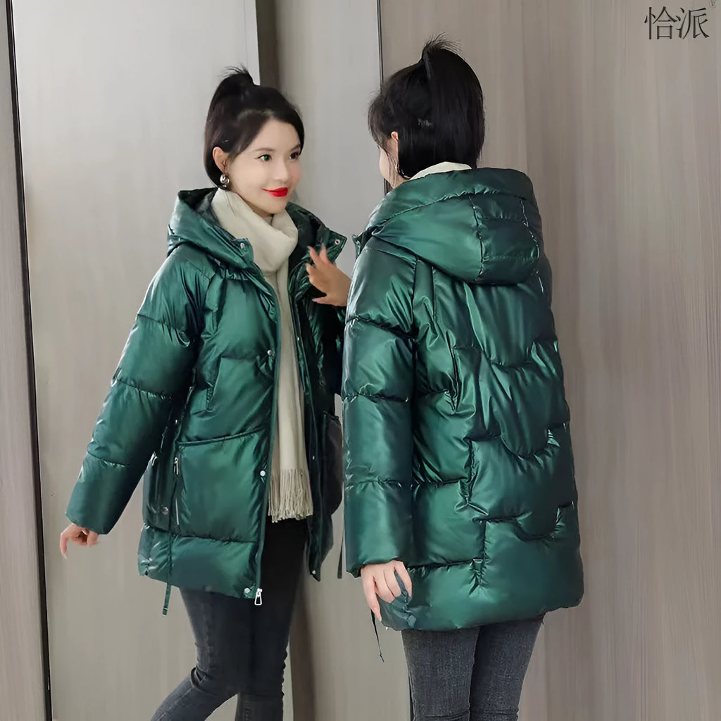 Women's green ultra-thin hooded winter jacket with long sleeves on a hanger.