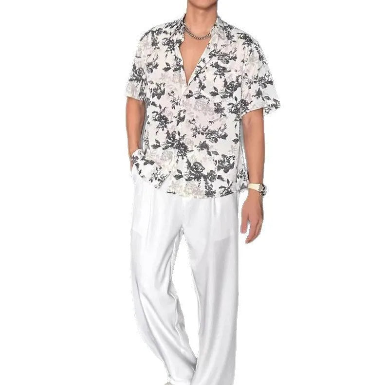 A loose-fitting, short sleeve casual shirt with a floral print, shown in a cardigan style.