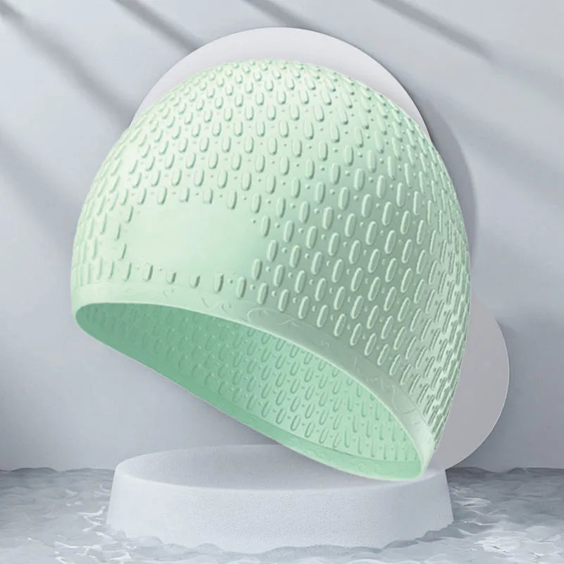 Silicone water drop swimming cap for adults in various solid colours on white background