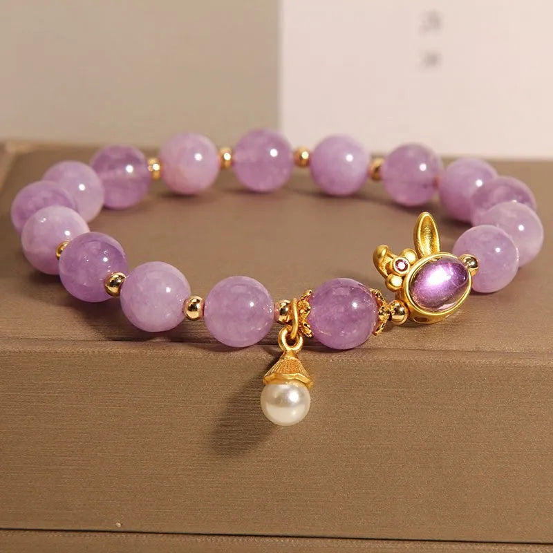 Mauve jade hare head pendant on a clear crystal bracelet, Mori style design.