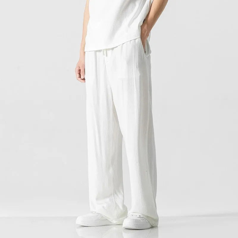 Men's beige linen-blend cropped trousers with a drawstring waist on a plain background.