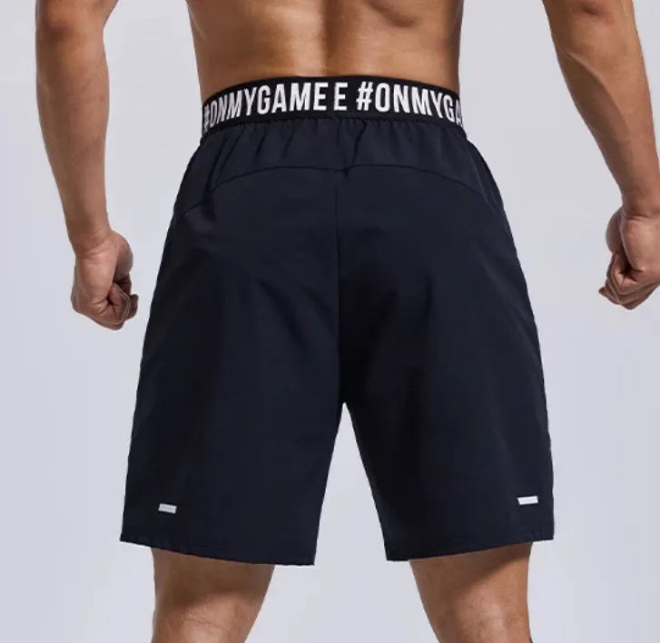 Men's loose black sports shorts with elastic waistband and letters design detail