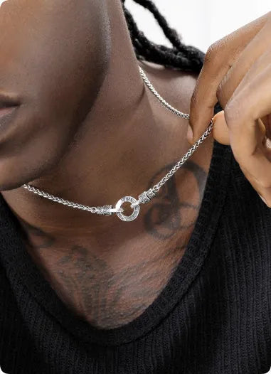 A sterling silver S925 clavicle necklace with a small pendant on a thin chain.