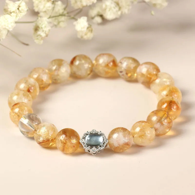 Citrine colour crystal bracelet with 10mm geometric beads on a wrist.