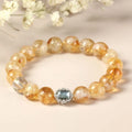 Citrine colour crystal bracelet with 10mm geometric beads on a wrist.