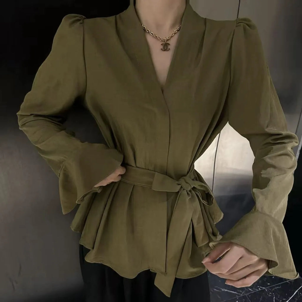 Women's black long sleeve shirt with an irregular collar and a tie closure at the neck.