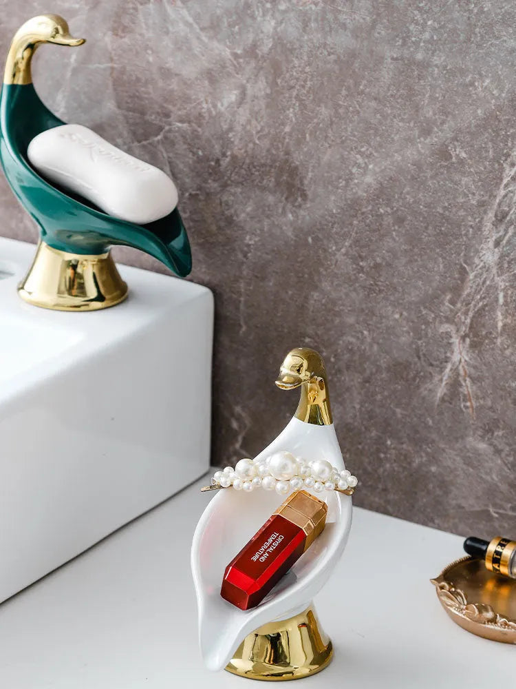 White ceramic swan soap dish with lid cover on bathroom countertop