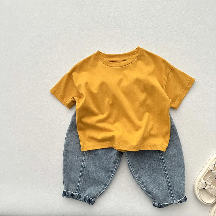 Light blue children's baggy denim jeans with elastic waistband, front view