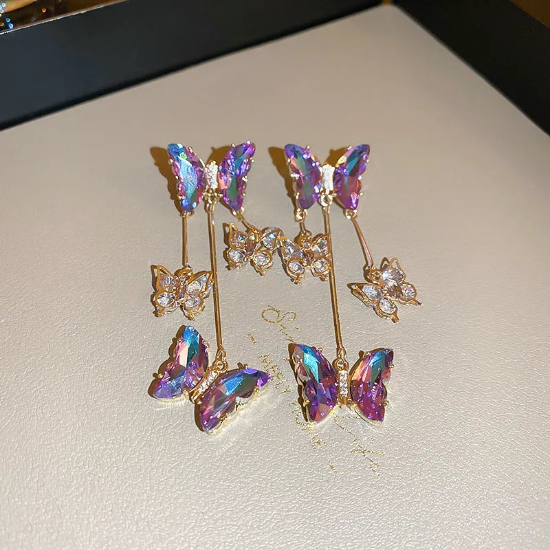 A pair of silver needle-blue purple butterfly tassel earrings with crystal flowers on a 4.5cm drop.
