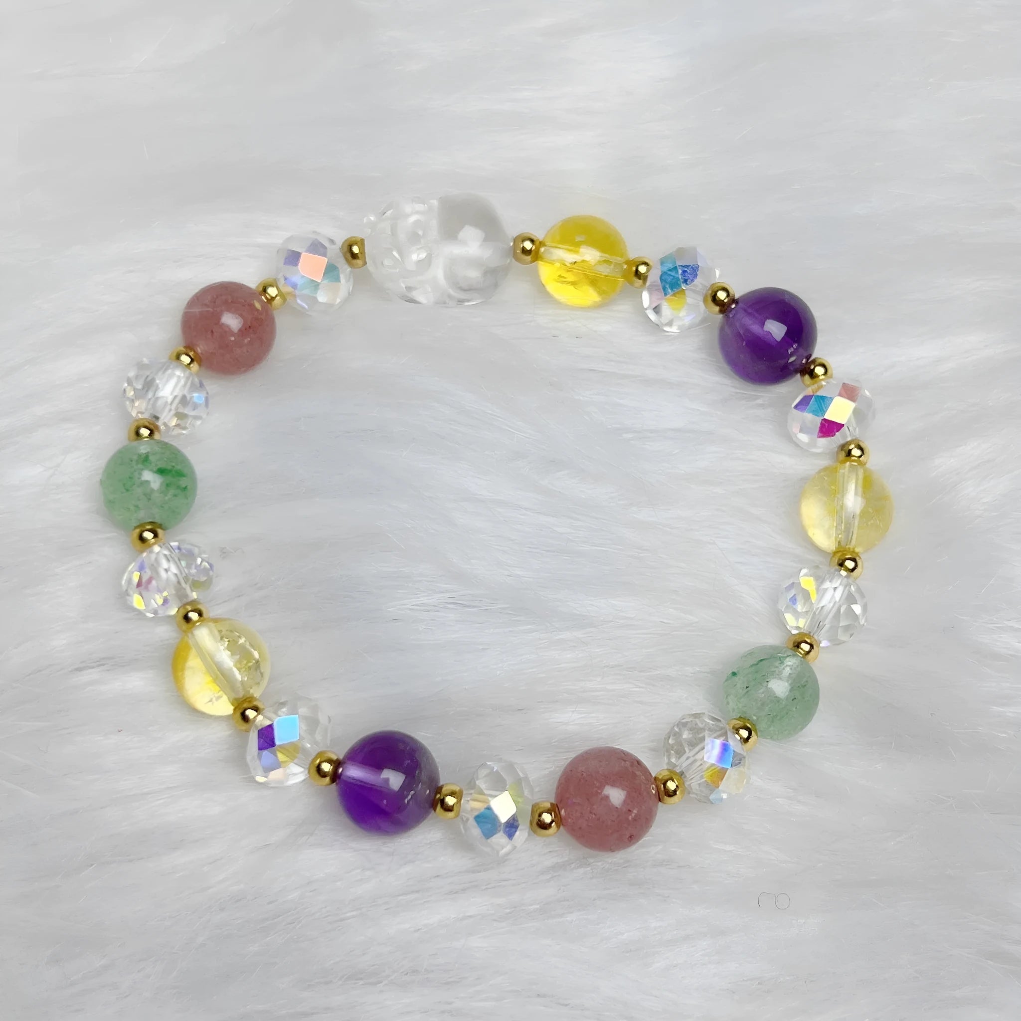 Close-up of a manually crafted crystal bracelet with a nine-tail fox centrepiece on a wrist.