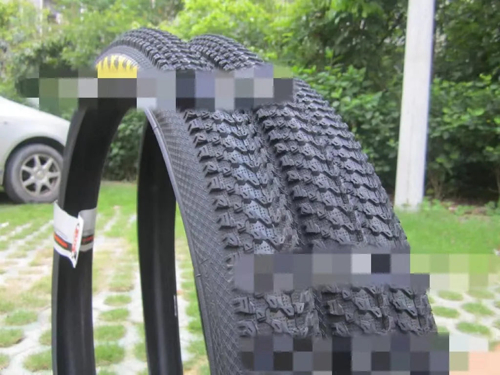 A mountain bike tyre showing tread pattern, with options for 26, 27.5, and 29-inch wheel sizes.