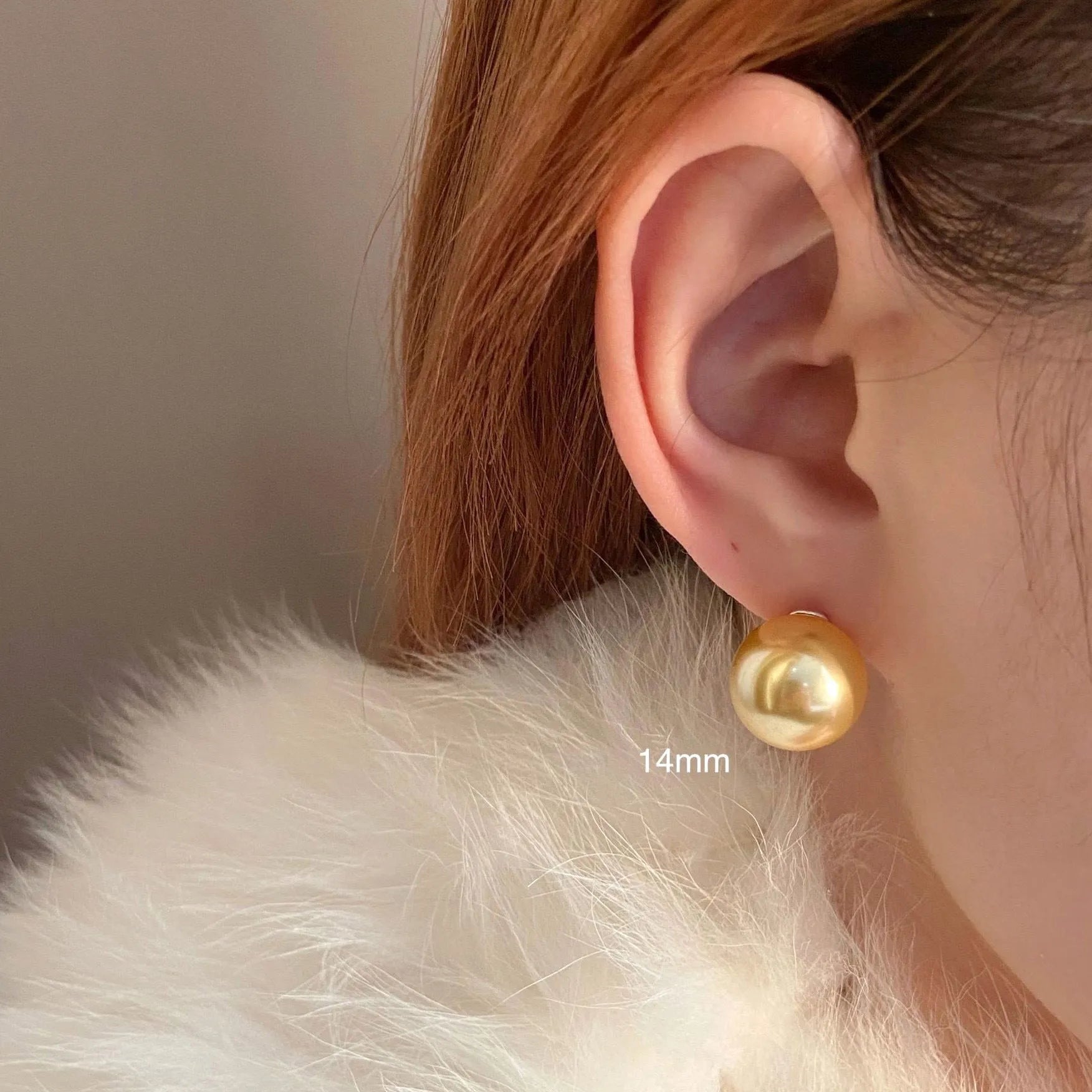 Geometric large pearl stud earrings with an eight-point star detail on a silver setting.