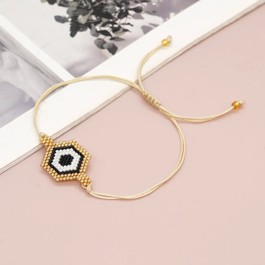 Hand-woven devil's eyes glass bead bracelet with blue eye detail in chic style for women