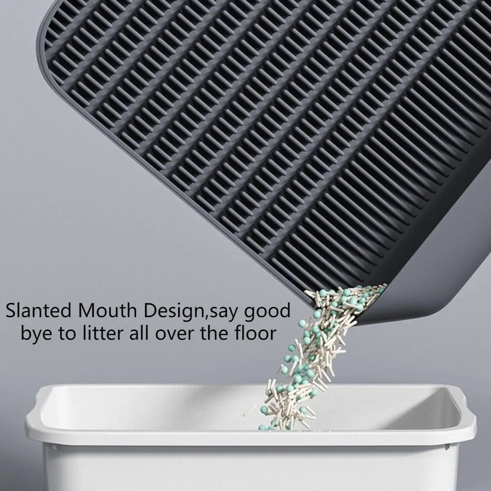 Black cat litter pedal with slanted design and textured grooves for litter containment