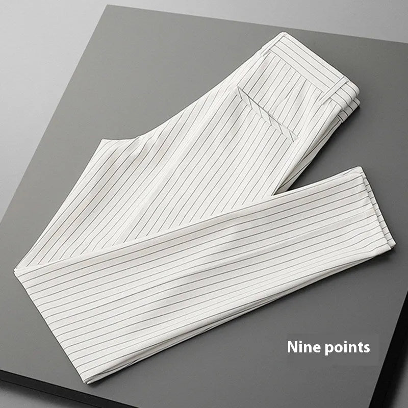 Men's thin striped loose suit pants with draping fit in black and white colours.