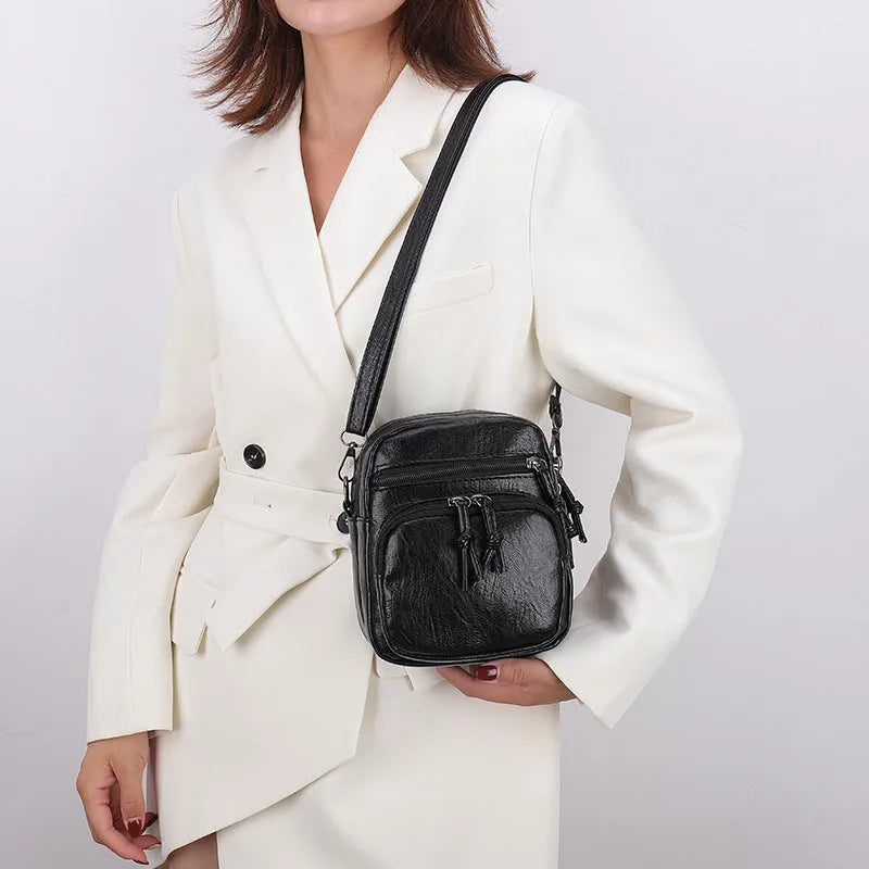 Women's soft PU leather mini shoulder bag with chain strap, square vertical shape, plain black finish, zipper closure