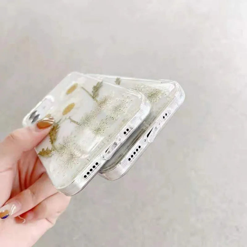 White epoxy daisy floral design on a clear TPU protective case for iPhone models.