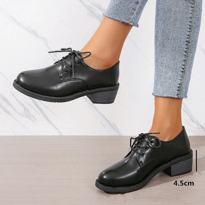 Black women's work shoes with thick rubber heel and soft sole, low top design with European styling