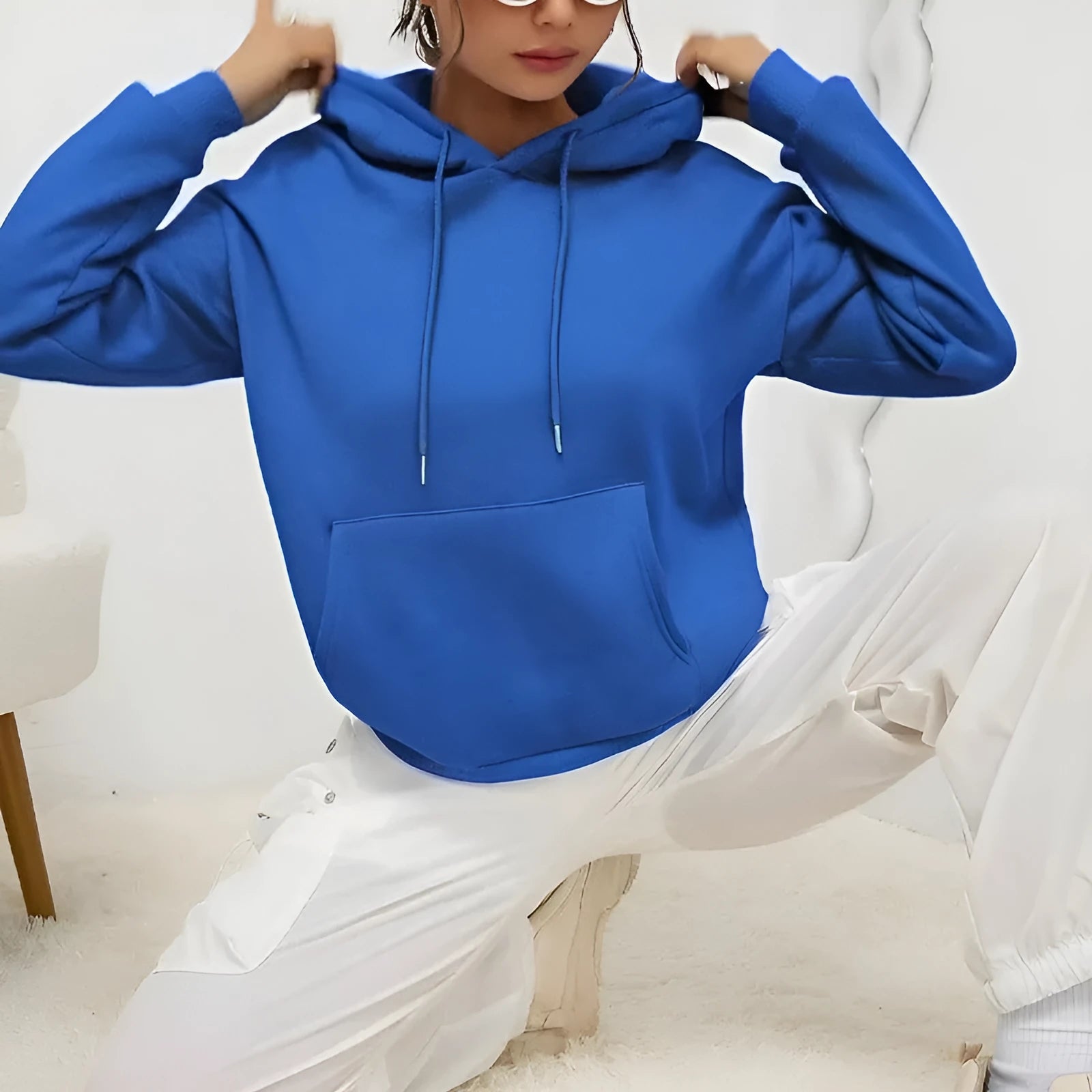 Women's loose grey hooded sweatshirt with a front pocket and drawstring.
