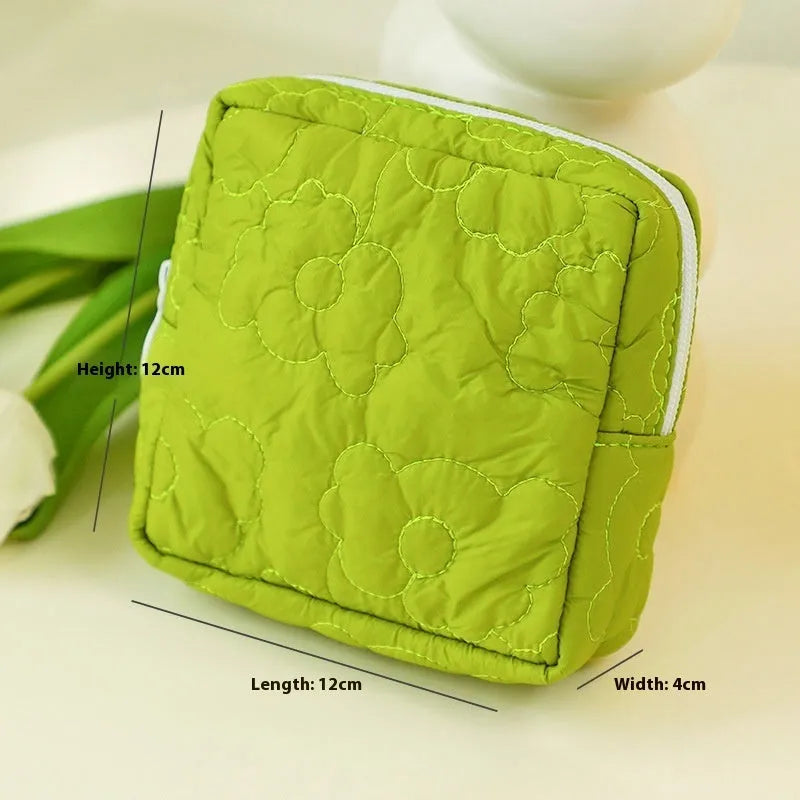 Quilted silk cosmetic storage bag in candy colours showing pink, yellow, blue, white and green options