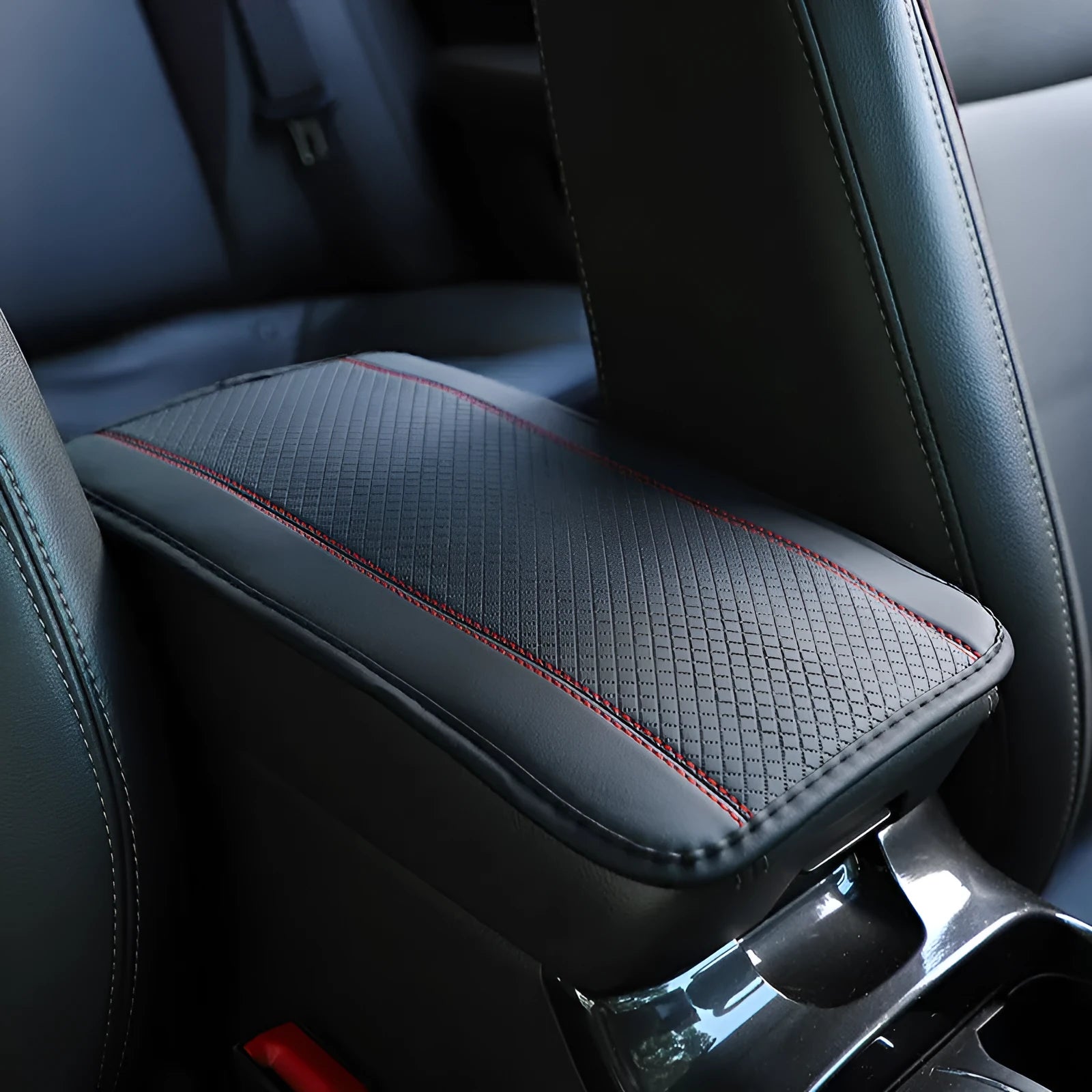 Automotive fibre leather embossed armrest box mat measuring 32x19cm in black with red cords colour