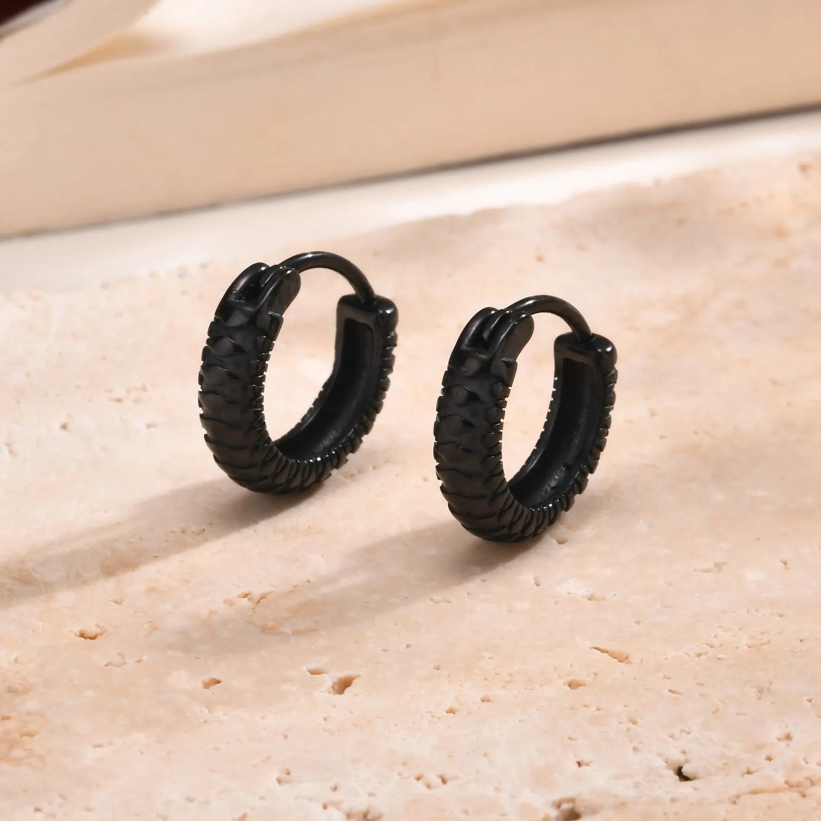 Stainless steel snake pattern stud earrings in black and gold colour options