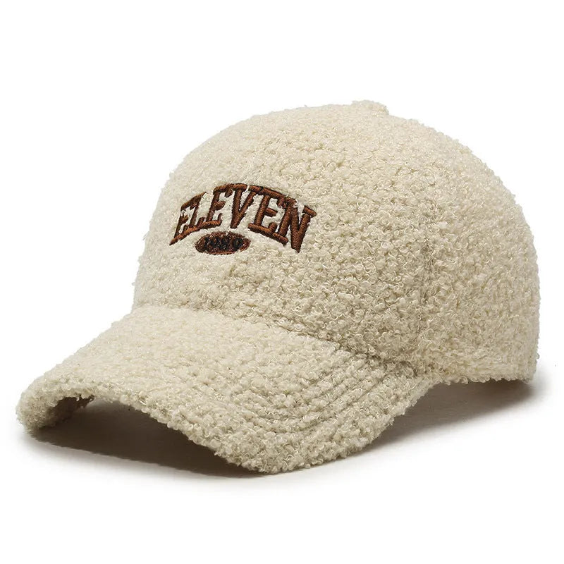 Adjustable lambskin winter baseball cap in black with dome crown and machine embroidery detail.