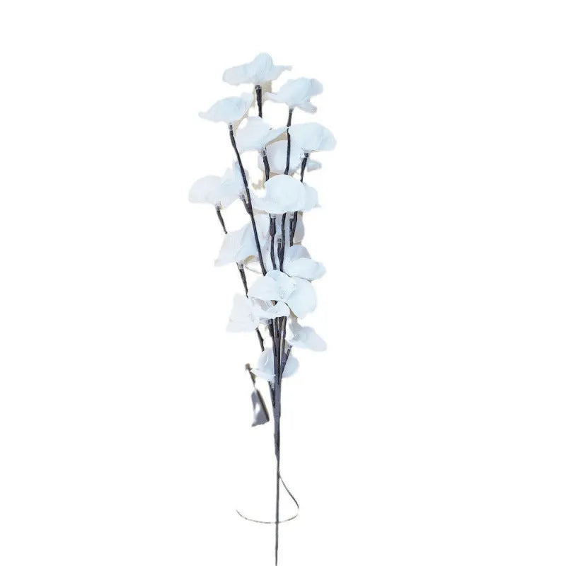Pink fabric-covered LED Phalaenopsis orchid branch light, 65cm long, with warm white bulbs illuminated on a dark surface.