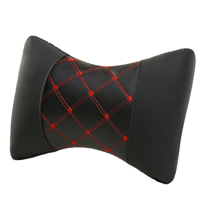 Black artificial leather car headrest pillow with quilted diamond pattern and coloured stitching.