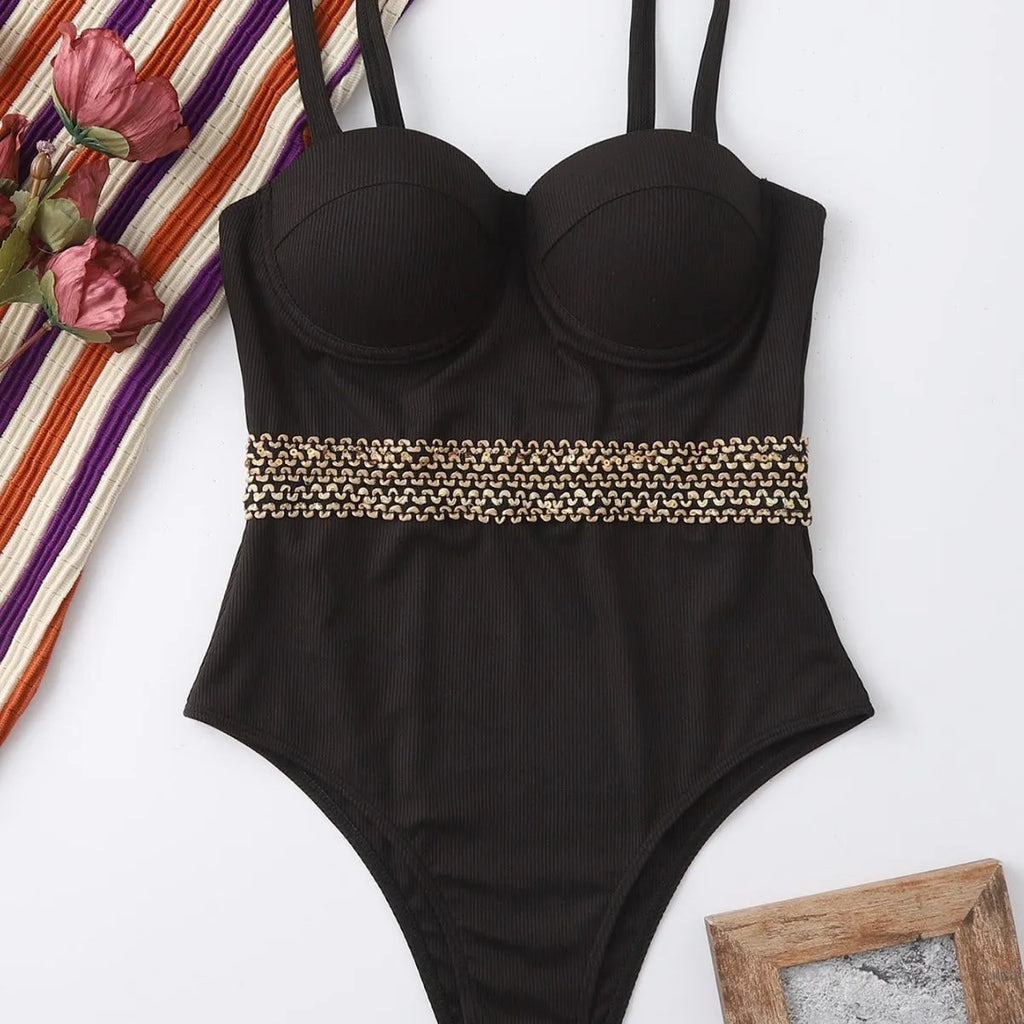 Black one-piece swimsuit with adjustable shoulder strap on a mannequin