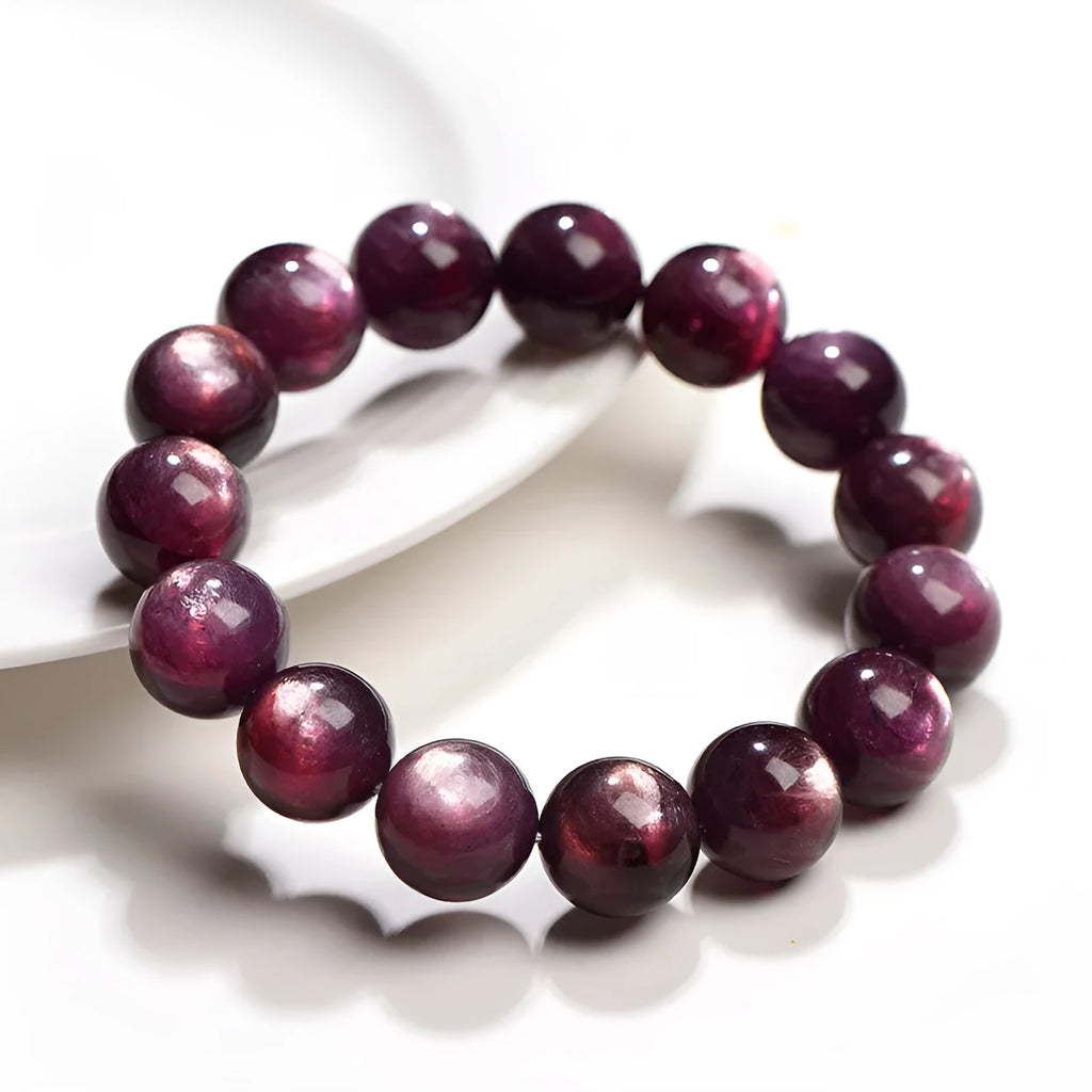 Natural purple lepidolite crystal round bead bracelet with adjustable cord on a wooden surface.