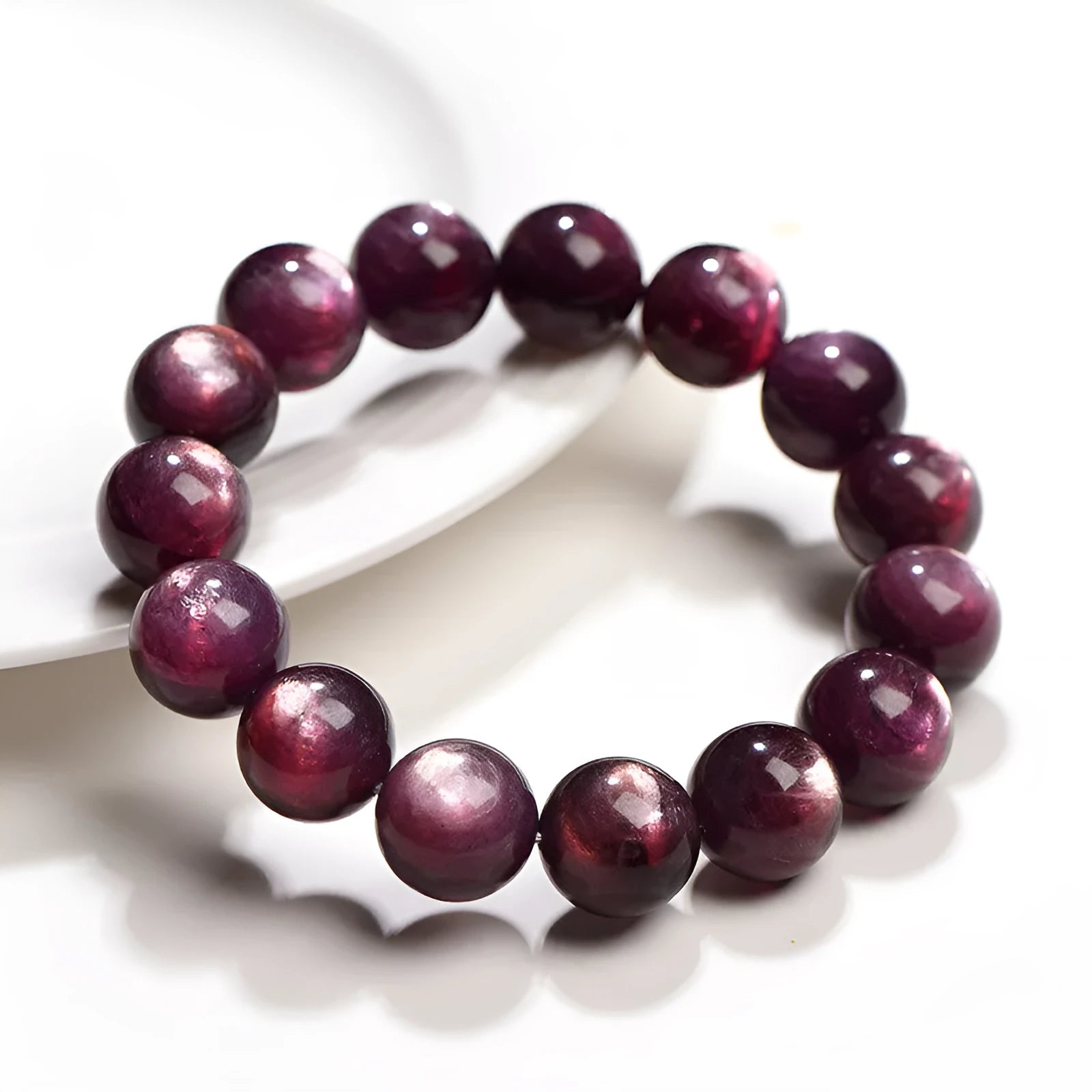 Natural purple lepidolite crystal round bead bracelet with adjustable cord on a wooden surface.