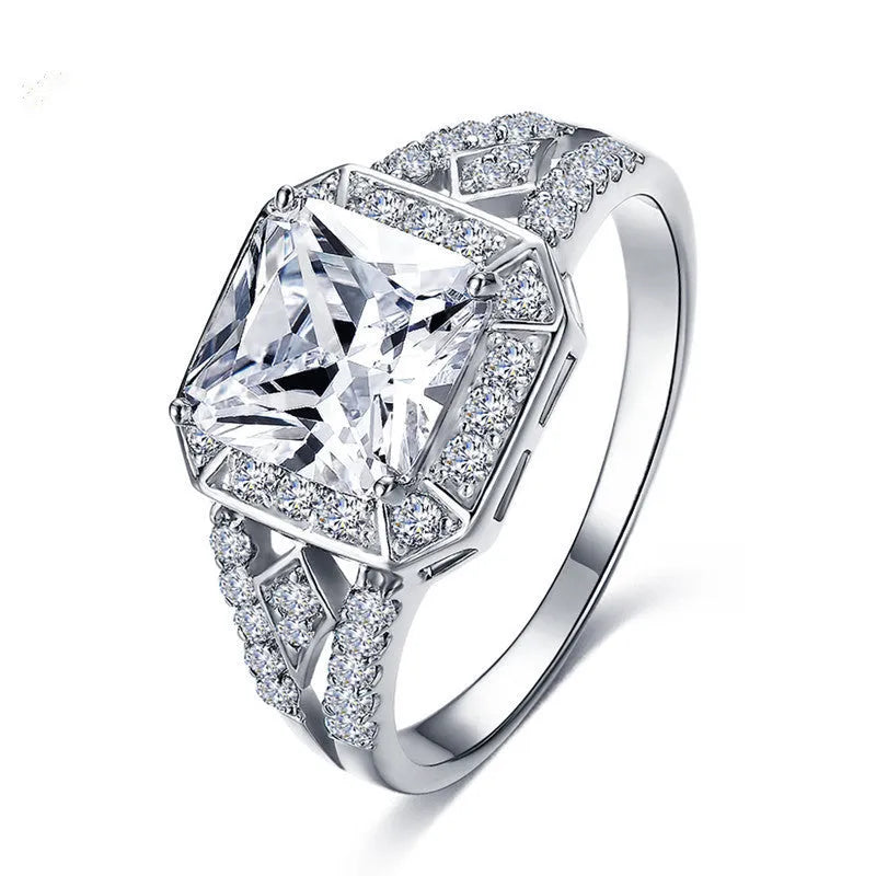 Platinum-colour hollow geometric ring with an inlaid cubic zirconia stone, shown from the side.