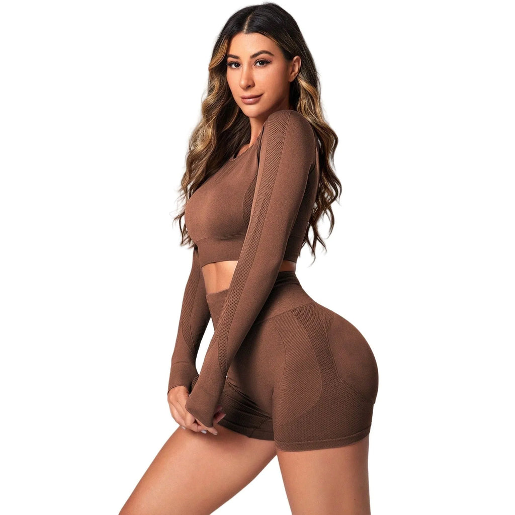 Women's black high-waist yoga pants and long-sleeve top set laid flat.
