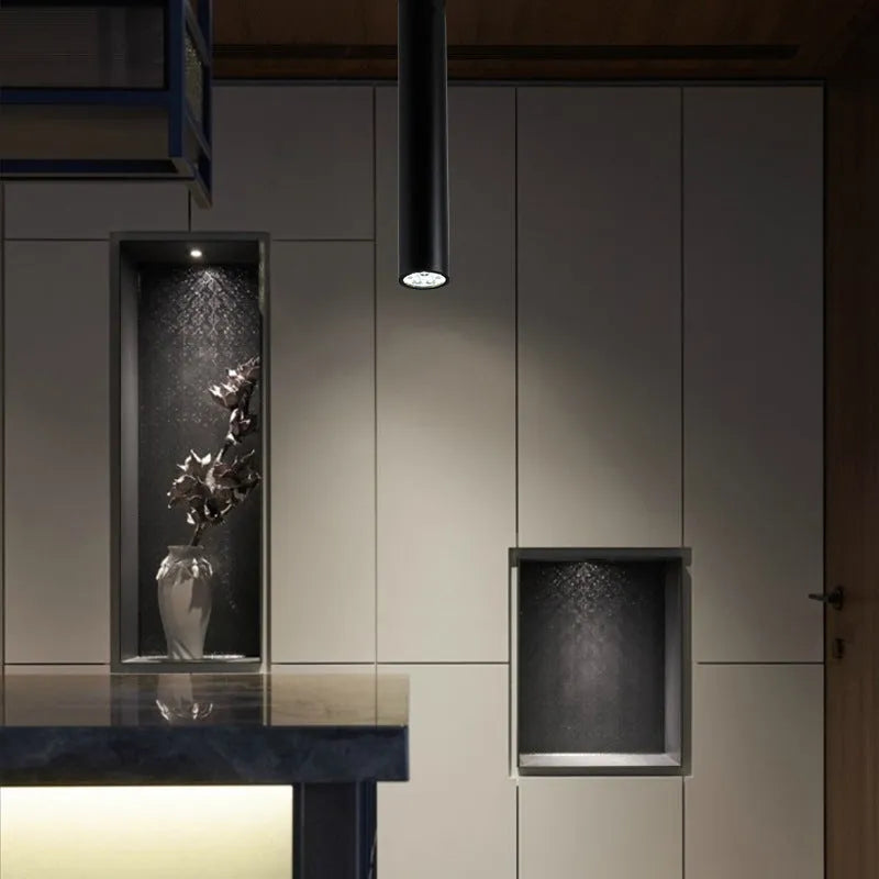 Black round surface mounted LED ceiling downlight spotlight in warm white or cool white light.