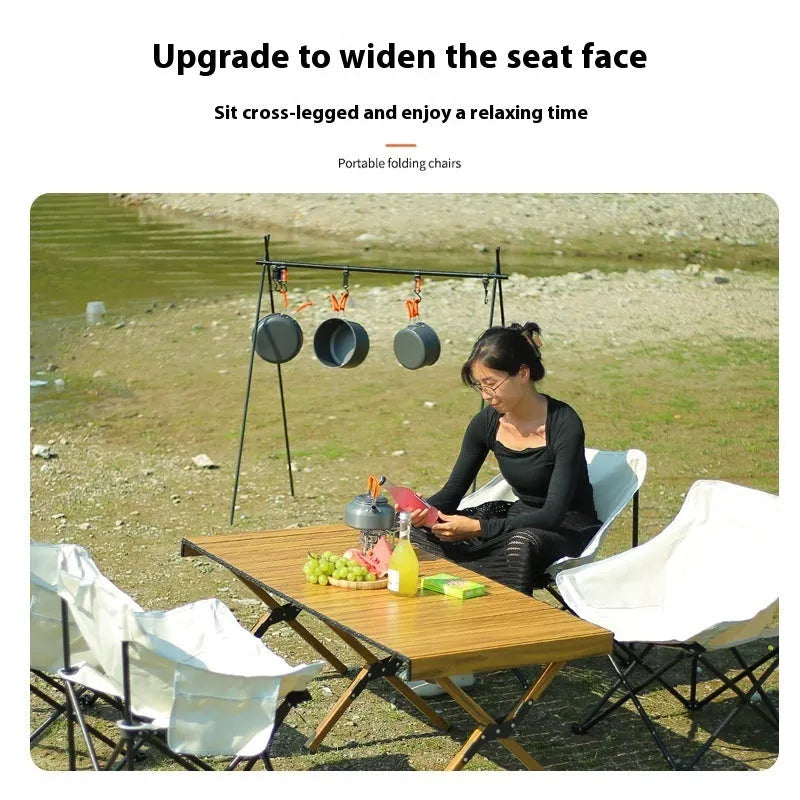 Beige portable folding chair with steel frame and Oxford cloth seat, unfolded for outdoor use.