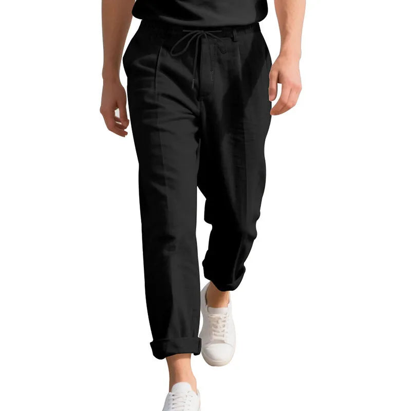 Men's light khaki linen trousers with a drawstring waist and straight leg on a hanger.