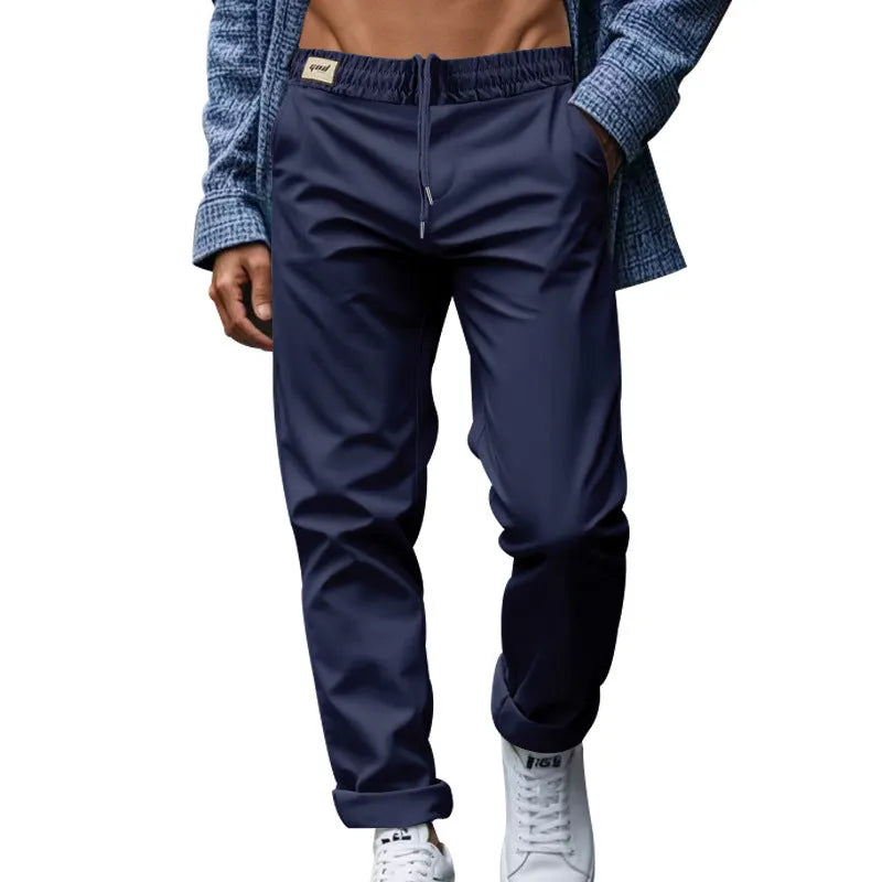 Men's loose fit drawstring trousers in solid colour Beige, side view showing straight leg and mid-waist drawstring closure.