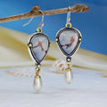 Retro blue geometric drop earrings with synthetic opal and pearl accents on white background
