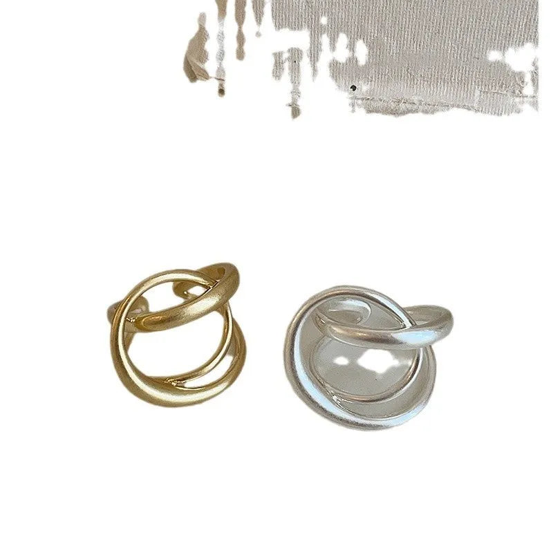 Geometric interlaced matte metal open ring for women in gold or silver colour.