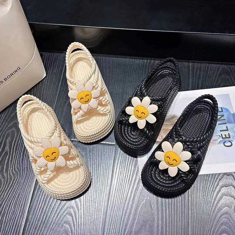 Women's PVC sandals with floral decorations and round toe design in beige colour