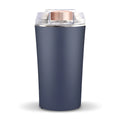 Blue mini flour mill and grinder with stainless steel construction on a kitchen counter.