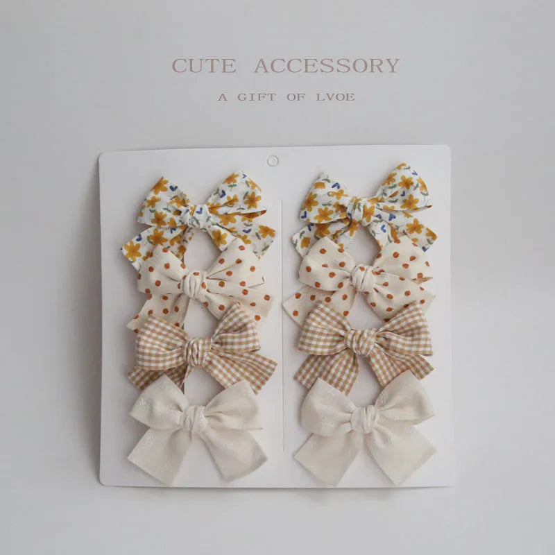 Children's cloth hairclips with dovetail bow design in multiple colour sets including beige brown grid dots