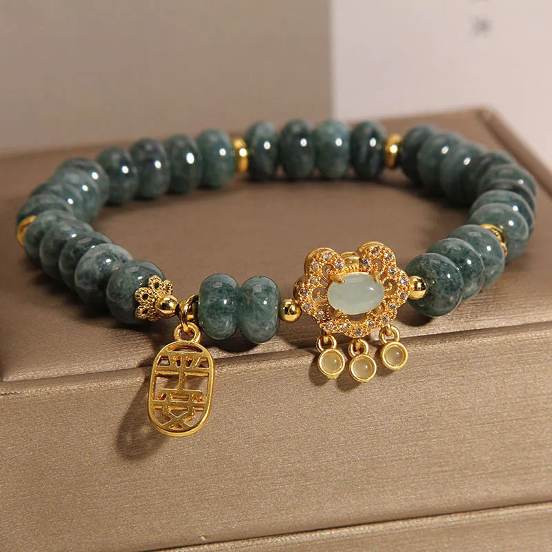 Women's bracelet with green jade abacus beads and a metallic safety lock clasp.